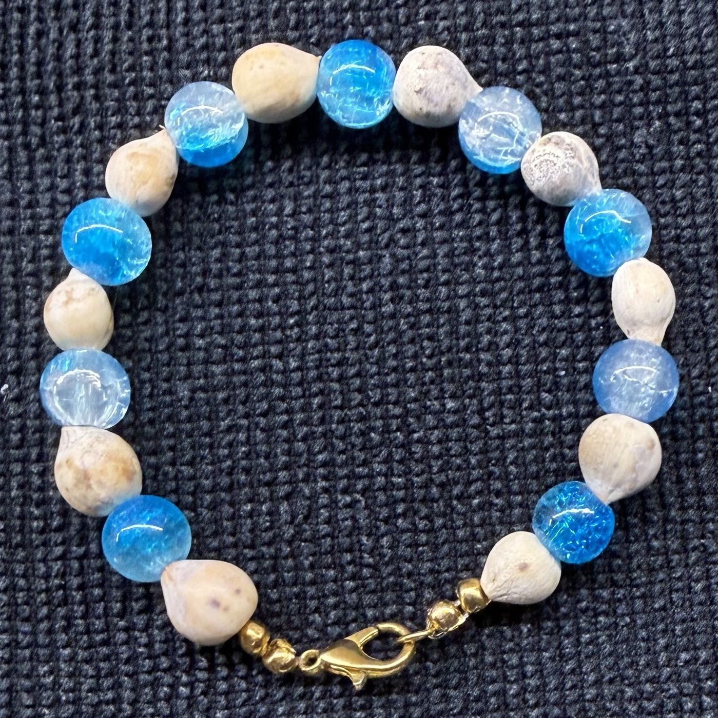 Bracelet 2, Blue Gatorade, 6.9": bright blue and pale blue crackle glass beads alternating with grey-white Job's tears seeds and a gold clasp.