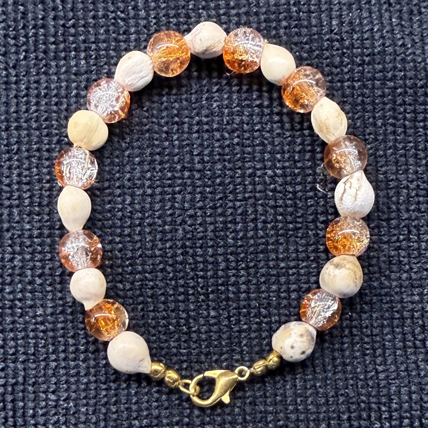 Bracelet 6, Pumpkin, 6.9": orange and clear crackle glass beads alternating with cream Job's tears seeds and a gold clasp.