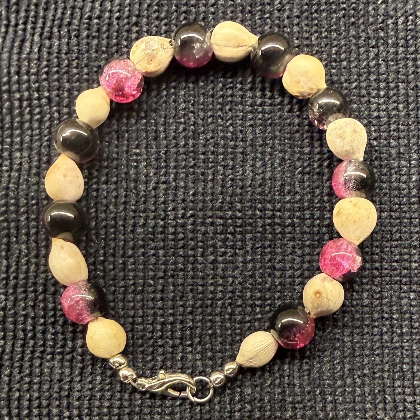 Bracelet 8, Bulls Eye, 7.5": smoky black and pink crackle glass beads alternating with cream Job's tears seeds and a silver clasp.