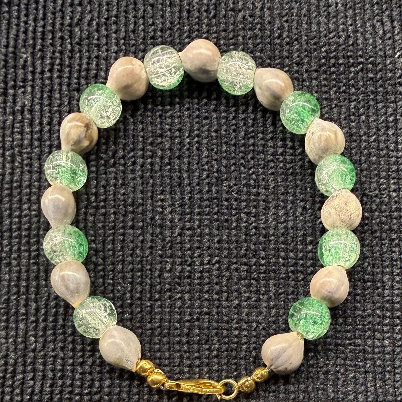 Bracelet 9, Christmas Light, 7.4": pale green crackle glass beads alternating with grey Job's tears seeds and a gold clasp.