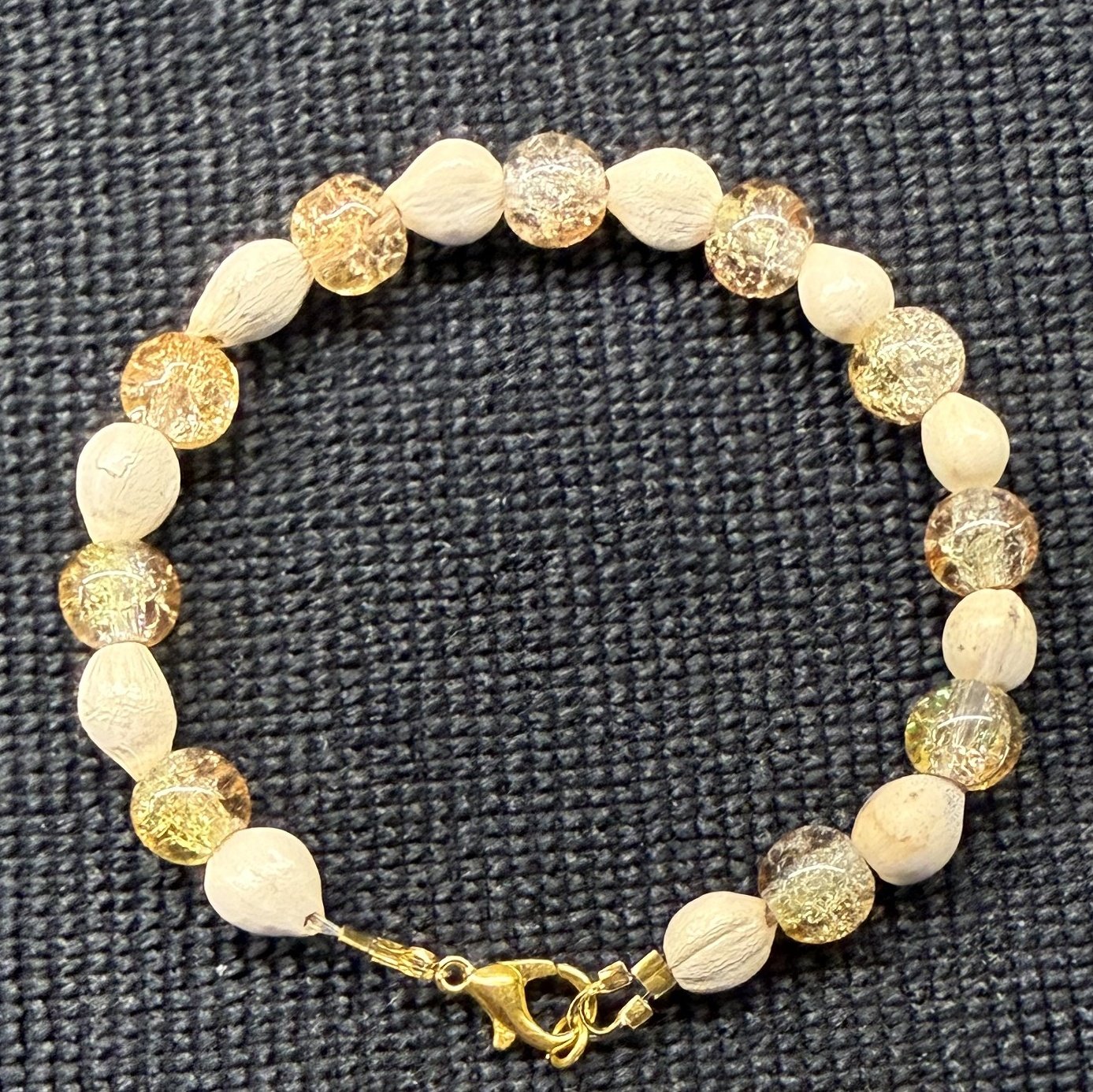 Bracelet 13, Fall, 7.2": pale gold and champagne crackle glass beads alternating with cream Job's tears seeds and a gold clasp.