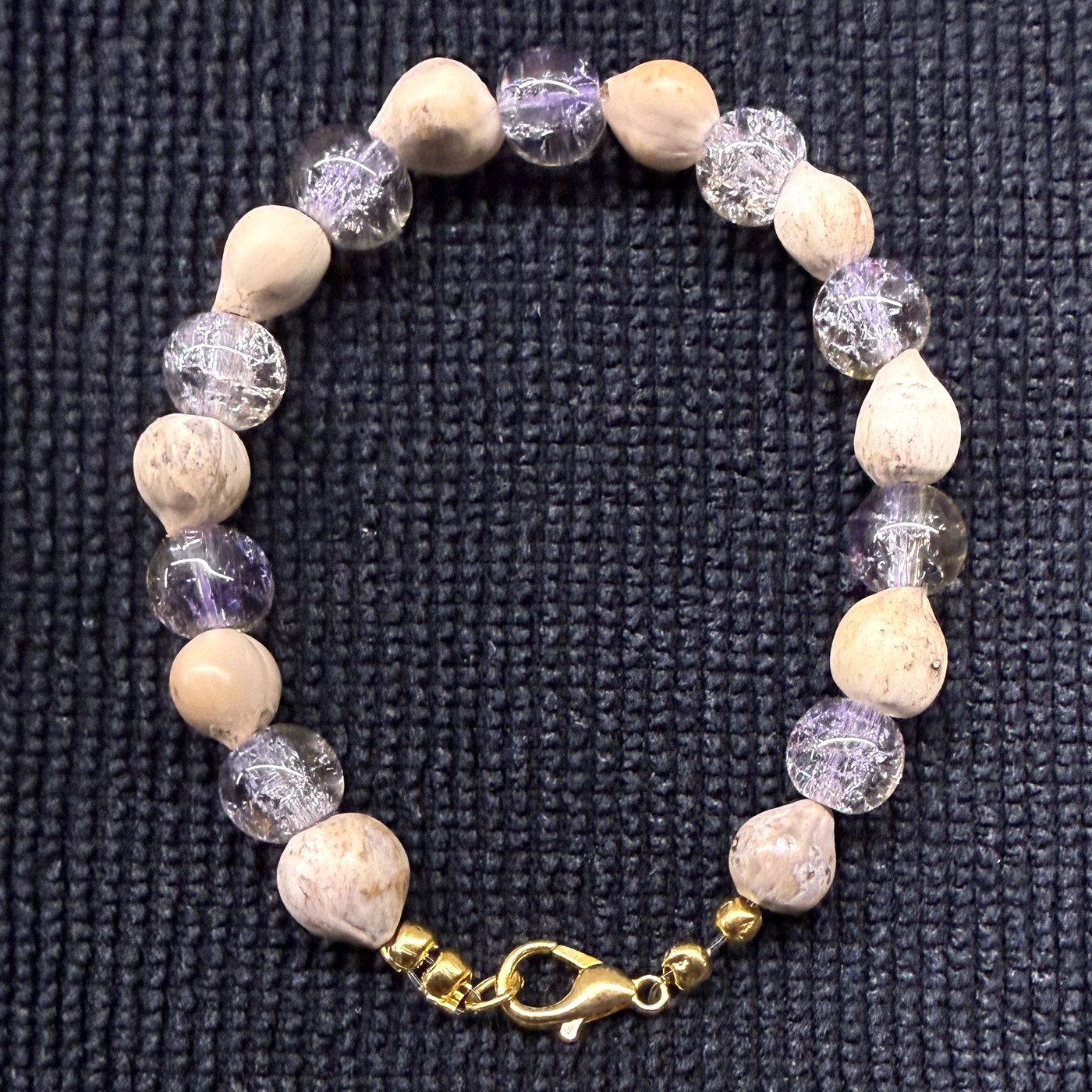 Bracelet 14, Purple Crocs, 6.9": pale lavender and clear crackle glass beads alternating with tan Job's tears seeds and a gold clasp.